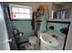 Small bathroom with light blue tile, a toilet, vanity and an overhead light at 26 College Dr, Babson Park, FL 33827