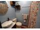 Bathroom features blue walls, a vanity and sink and a multicolored shower curtain at 26 College Dr, Babson Park, FL 33827