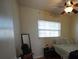 Modest bedroom featuring a window with blinds and a ceiling fan with an attached light fixture at 26 College Dr, Babson Park, FL 33827