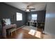 Cozy bedroom has wood floors, two windows, a ceiling fan and an area rug at 26 College Dr, Babson Park, FL 33827