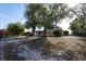 Exterior daytime shot of a charming single-story home surrounded by mature trees at 26 College Dr, Babson Park, FL 33827
