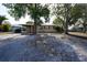 Charming single-story home with mature trees and red shutters for added curb appeal at 26 College Dr, Babson Park, FL 33827