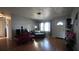 Comfortable living room with lots of natural light, wood floors, and neutral paint at 26 College Dr, Babson Park, FL 33827