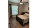 Charming bedroom featuring wood-look floors, wood trim bed, and a ceiling fan with overhead light at 2943 Annalee Rd, St Cloud, FL 34771
