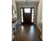 Beautiful foyer with wood-look tile flooring and a stylish console table at 2943 Annalee Rd, St Cloud, FL 34771