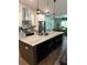 Modern kitchen featuring stainless steel appliances, island with seating, and pendant lighting at 2943 Annalee Rd, St Cloud, FL 34771