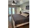 Spacious main bedroom with french doors, stylish decor, and wood-look tile flooring at 2943 Annalee Rd, St Cloud, FL 34771