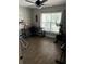Bright office space featuring a ceiling fan, wood-look tile flooring, desk, and exercise equipment at 2943 Annalee Rd, St Cloud, FL 34771