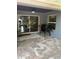 Covered patio with ceiling fan, tile floor, grill, and sliding door for outdoor dining at 2943 Annalee Rd, St Cloud, FL 34771
