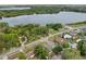 Beautiful aerial shot of houses near a tranquil lake, featuring lush landscaping and a swimming pool at 301 Lake Ned Rd, Winter Haven, FL 33884