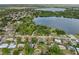 Panoramic aerial view showcasing homes near a large lake surrounded by lush green trees at 301 Lake Ned Rd, Winter Haven, FL 33884