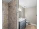 Bathroom with tiled shower and vanity at 301 Lake Ned Rd, Winter Haven, FL 33884