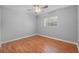 This bedroom offers hardwood floors, a ceiling fan, a window and neutral paint at 301 Lake Ned Rd, Winter Haven, FL 33884