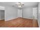Spacious bedroom with wood floors, two entryways, and a ceiling fan at 301 Lake Ned Rd, Winter Haven, FL 33884