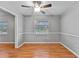 Dining room with hardwood floors, ceiling fan, and ample natural light at 301 Lake Ned Rd, Winter Haven, FL 33884