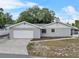 This home features a garage and a covered lanai at 301 Lake Ned Rd, Winter Haven, FL 33884