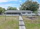 Charming single-story home with a screened-in porch and walkway at 301 Lake Ned Rd, Winter Haven, FL 33884