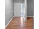 Hallway featuring laminate flooring, neutral paint, and white trim at 301 Lake Ned Rd, Winter Haven, FL 33884