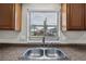 Kitchen sink and countertops with natural light from window with view of front yard and neighborhood at 301 Lake Ned Rd, Winter Haven, FL 33884