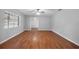 Bright and airy living room with hardwood floors and a ceiling fan at 301 Lake Ned Rd, Winter Haven, FL 33884