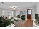 Comfortable living room featuring green furniture, hardwood floors, and a large area rug at 301 Lake Ned Rd, Winter Haven, FL 33884