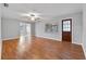Open-concept living room with wood floors, ceiling fan, window, and a view into the dining area at 301 Lake Ned Rd, Winter Haven, FL 33884