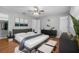 Main bedroom with hardwood floors, a large bed, modern furnishings, and neutral paint at 301 Lake Ned Rd, Winter Haven, FL 33884