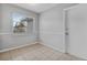 Neutral room featuring a window, ceramic tile floor, baseboards, and a white painted door at 301 Lake Ned Rd, Winter Haven, FL 33884