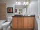 Bright bathroom with tub, toilet, vanity with storage, and large mirror at 3071 Seaview Castle Dr, Kissimmee, FL 34746