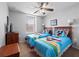 Bedroom with twin beds, ceiling fan, dresser and large window with blinds at 3071 Seaview Castle Dr, Kissimmee, FL 34746