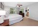 Bright bedroom with large window, ceiling fan, and en-suite bathroom at 3071 Seaview Castle Dr, Kissimmee, FL 34746