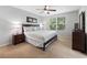 Bedroom with plush carpet, large window with blinds, and a wooden bed frame at 3071 Seaview Castle Dr, Kissimmee, FL 34746