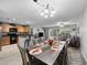 Dining room open to kitchen and living area with modern table and chairs and sliding door to back yard at 3071 Seaview Castle Dr, Kissimmee, FL 34746