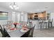 Open-concept dining area flowing seamlessly into the kitchen with stylish bar seating at 3071 Seaview Castle Dr, Kissimmee, FL 34746