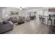 Open concept living space with hardwood floors, modern furniture, and stainless steel kitchen appliances at 3071 Seaview Castle Dr, Kissimmee, FL 34746