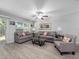 Bright living room with comfortable sofas, a ceiling fan, and large windows offering natural light at 3071 Seaview Castle Dr, Kissimmee, FL 34746