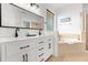 Bright bathroom with double sink vanity, soaking tub, and glass enclosed shower at 308 Yellow Snapdragon Dr, Davenport, FL 33837