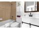 This bathroom features a shower/tub combo and single sink vanity with sliding barn door at 308 Yellow Snapdragon Dr, Davenport, FL 33837