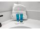 Close up of vanity with complimentary soaps, shampoos and plush white towel at 308 Yellow Snapdragon Dr, Davenport, FL 33837