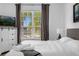 Bright bedroom features large window, gray accents, comfortable bedding, and lots of natural light at 308 Yellow Snapdragon Dr, Davenport, FL 33837