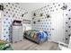 Bright bedroom with a Harry Potter theme, featuring a single bed and unique decor at 308 Yellow Snapdragon Dr, Davenport, FL 33837