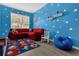 Bright bedroom featuring playful Toy Story themed decor and wood-look floors at 308 Yellow Snapdragon Dr, Davenport, FL 33837