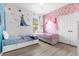 Light-filled bedroom featuring two single beds and a whimsical Frozen-themed decor at 308 Yellow Snapdragon Dr, Davenport, FL 33837