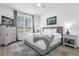 Cozy bedroom with natural light, a TV, comfortable bed, and stylish decor at 308 Yellow Snapdragon Dr, Davenport, FL 33837
