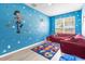Charming bedroom with playful Toy Story themed decor and lots of natural light at 308 Yellow Snapdragon Dr, Davenport, FL 33837