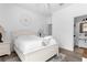 This bedroom features a white-themed design with wood laminate flooring and an ensuite bathroom at 308 Yellow Snapdragon Dr, Davenport, FL 33837