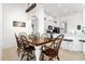Elegant dining area with a wooden table, stylish chairs, and a rustic lighting fixture at 308 Yellow Snapdragon Dr, Davenport, FL 33837
