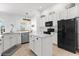 Well-equipped kitchen with white cabinets, modern appliances, and a functional island at 308 Yellow Snapdragon Dr, Davenport, FL 33837