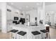Modern kitchen featuring white cabinets, stainless steel appliances, and a large marble island at 308 Yellow Snapdragon Dr, Davenport, FL 33837