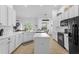 Spacious kitchen featuring an island, stainless steel appliances, and modern cabinetry at 308 Yellow Snapdragon Dr, Davenport, FL 33837